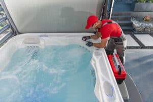 A technician works on a hot tub.